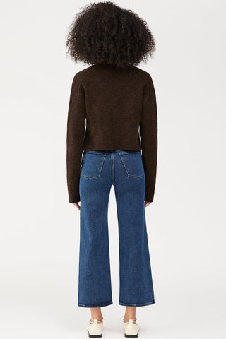 Back view of model wearing DL1961 Hepburn high rise wide leg jeans. 