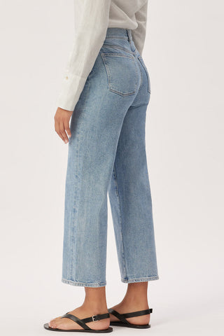 Side view of DL1961 organic cotton Hepburn wide leg jeans in Reef wash. 