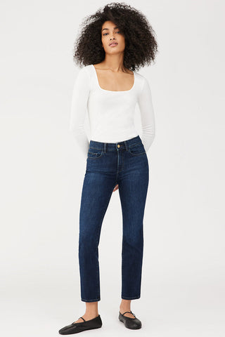 Model wearing DL1961 Mara straight mid rise jeans. 