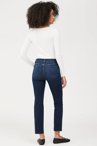 Back view of model wearing DL1961 Mara straight mid rise jeans. 