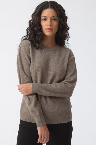 Model wearing oat brown Yak wool O-Neck sweater by Dinadi. 