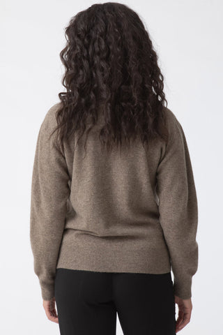 Back view of model wearing oat brown Yak wool O-Neck sweater by Dinadi. 