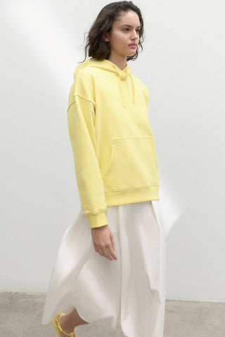 Model wearing lemonade yellow organic and recycled cotton Bottrop Sweater by Ecoalf. 