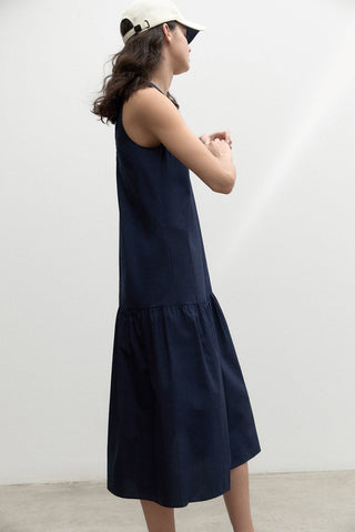 Model wearing navy organic cotton Malaquita dress by Ecoalf. 