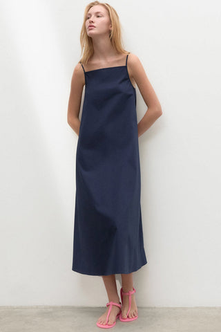 Model wearing navy organic cotton Perla dress by Ecoalf. 