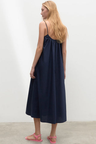 Model wearing navy organic cotton Perla dress by Ecoalf. 
