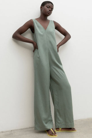 Model wearing sage green relaxed fit wide leg Turquesa Jumpsuit by Ecoalf. 