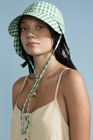 Model wearing green gingham Hansel from Basel Tulip bucket hat. 