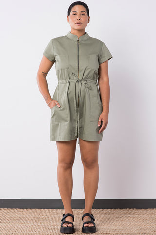 Model wearing sage coloured OEKO-TEK organic cotton zip up short ANATH jumpsuit by Jennifer Glasgow. 