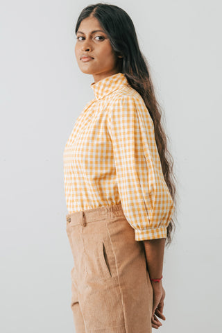 Side view of model wearing the Jennifer Glasgow Bondi Blouse in yellow and white check flannel. 