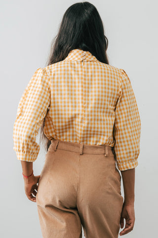 Back view of model wearing the Jennifer Glasgow Bondi Blouse in yellow and white check flannel. 