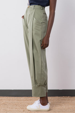 Side view of sage organic cotton pleated Jennifer Glasgow Ceres pants with cuffed ankle.