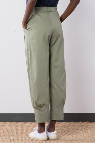 Back view of sage organic cotton pleated Jennifer Glasgow Ceres pants with cuffed ankle.
