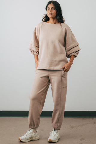 Model wearing fawn colour organic cotton Jennifer Glasgow Ridley Sweatpants. 