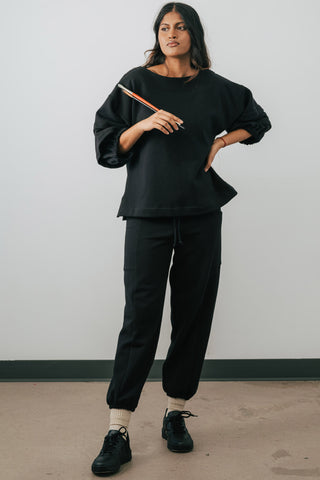 Model wearing black colour organic cotton Jennifer Glasgow Ridley Sweatpants. 