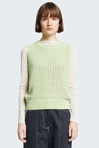 Model wearing green sleeveless crochet Arch Vest by Kloke.  