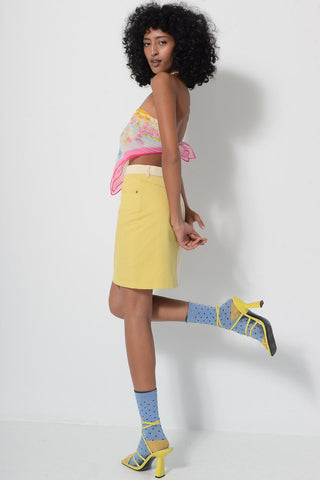 Model wearing two-tone yellow denim Billie Skirt by Kurt Lyle.