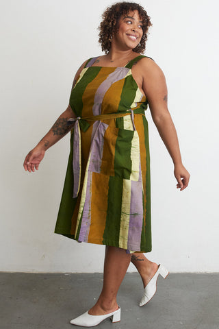 Side view of model wearing organic cotton A-Line Osei Duro dress in Speedboat print. 