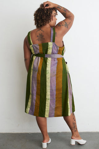 Back view of model wearing organic cotton A-Line Osei Duro dress in Speedboat print. 