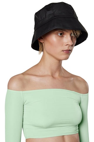 Model wearing unisex waterproof RAINS bucket hat in black. 