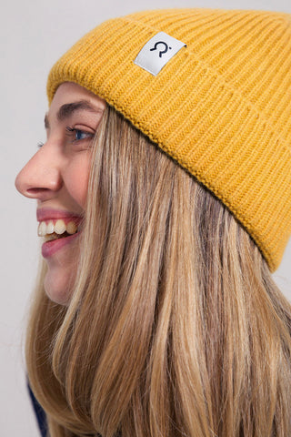 Model wearing yellow recycled cashmere Marcello Toque by Rifo. 
