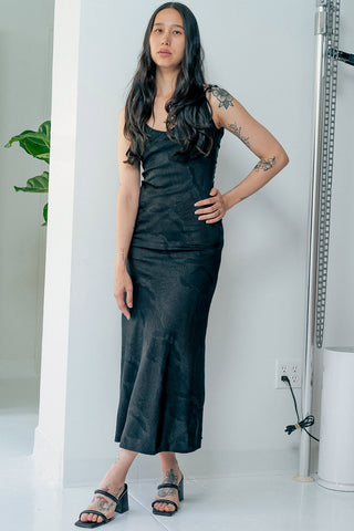 Model wearing hand printed black cupro Rujuta Sheth Monica slip dress. 