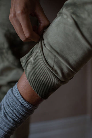 Close-up of cuff of The Simple Folks organic cotton moss tie dye track pants. 